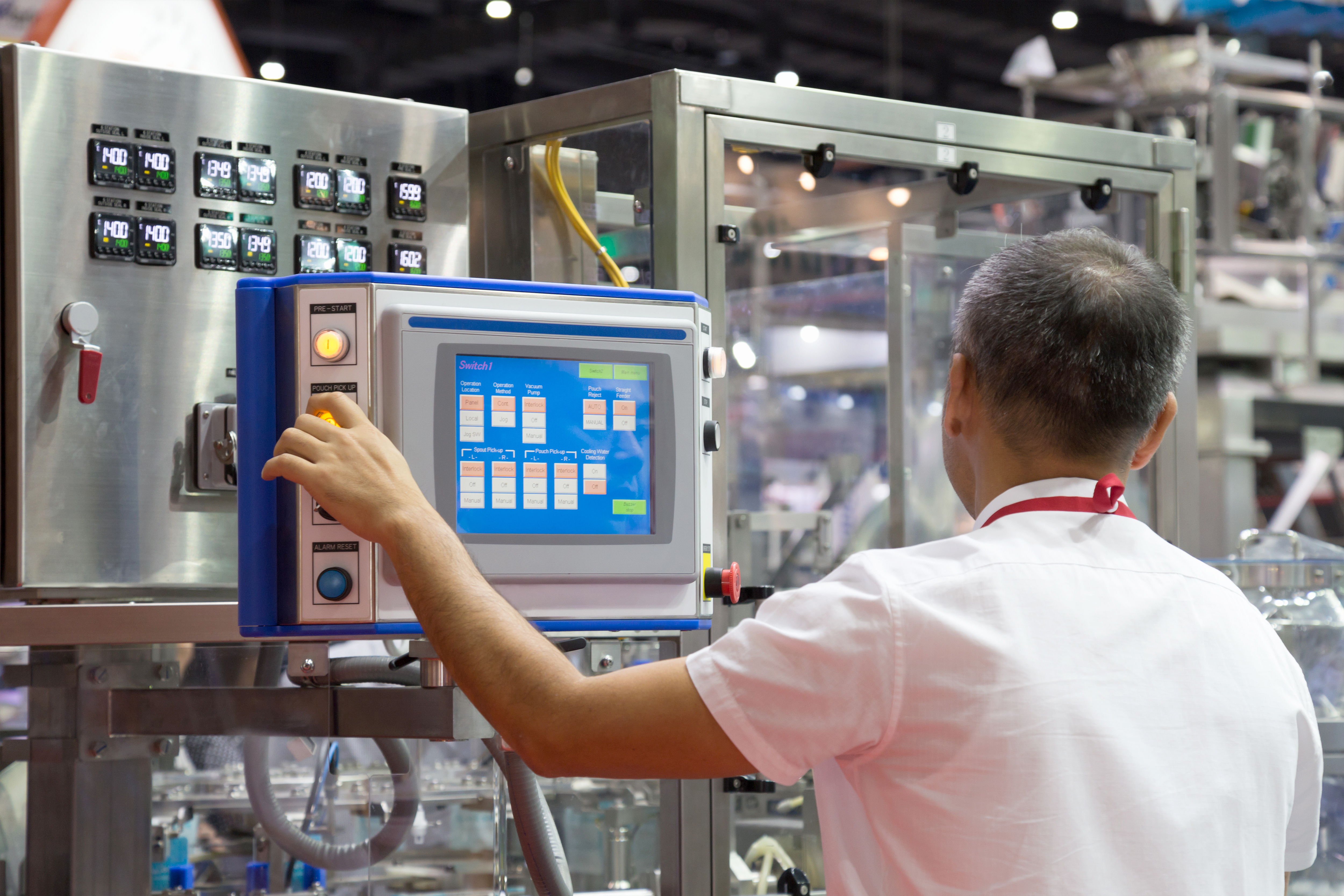 Man using a control panel in an automated factory